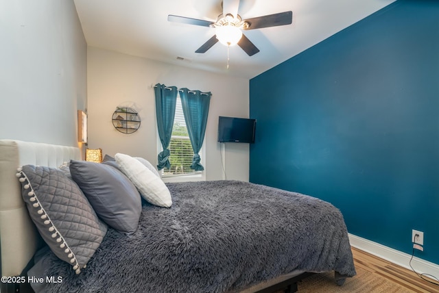 106 NW 8th St, Oak Island, NC 28465 - bedroom featuring wood finished floors, ceiling fan, and baseboards