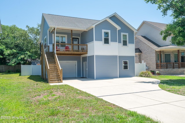 106 NW 8th St, Oak Island, NC 28465 - view of front of property featuring covered porch, driveway, stairs, and an attached garage