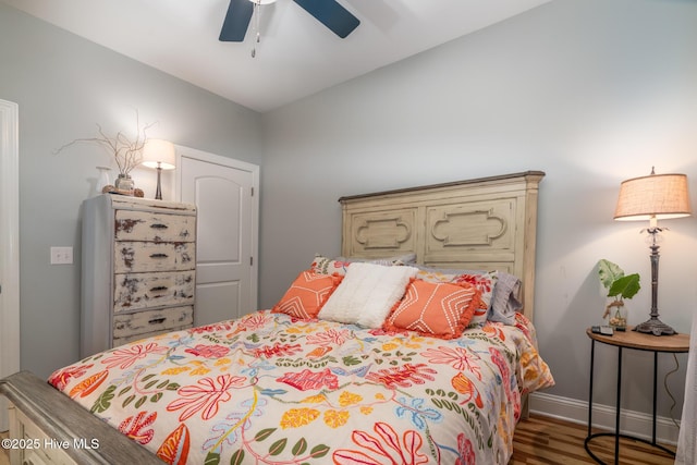106 NW 8th St, Oak Island, NC 28465 - bedroom featuring wood finished floors, a ceiling fan, and baseboards