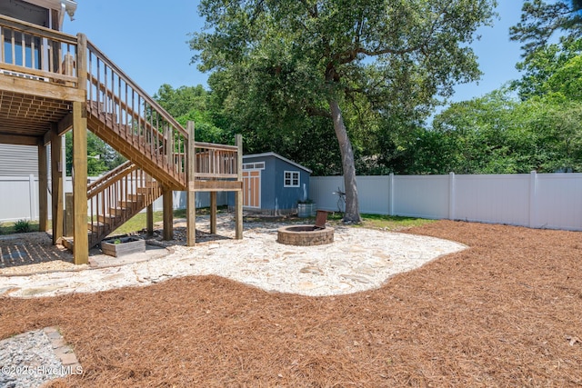 106 NW 8th St, Oak Island, NC 28465 - fenced backyard featuring a fire pit, stairs, and a patio area