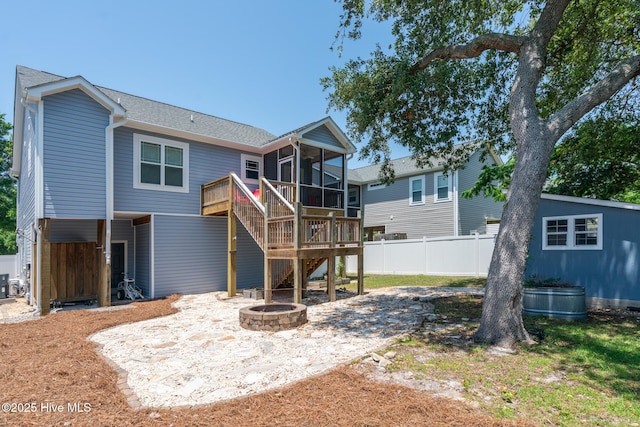 106 NW 8th St, Oak Island, NC 28465 - rear view of house with a sunroom, an outdoor fire pit, stairs, a patio, and central air condition unit