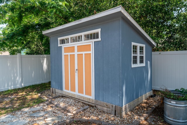 106 NW 8th St, Oak Island, NC 28465 - view of shed with a fenced backyard