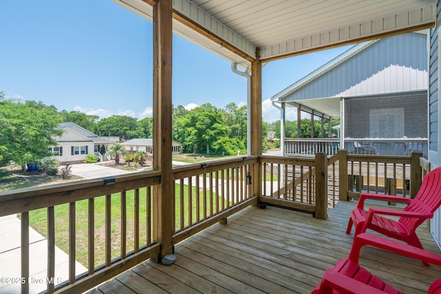 106 NW 8th St, Oak Island, NC 28465 - deck featuring a sunroom and a lawn