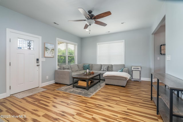 106 NW 8th St, Oak Island, NC 28465 - living area featuring baseboards, a ceiling fan, and light wood-style flooring