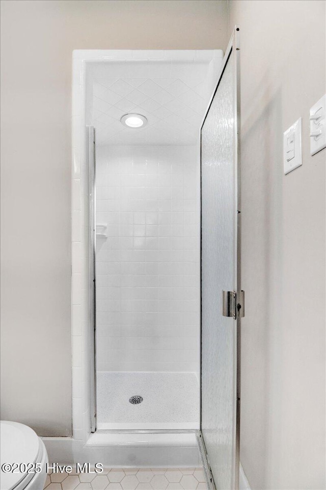 1102 Elanor Ave, Goldsboro, NC 27530 - full bathroom with a stall shower, toilet, and tile patterned floors