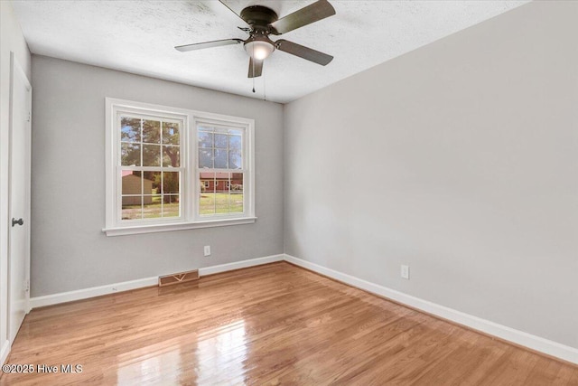1102 Elanor Ave, Goldsboro, NC 27530 - empty room with light wood-type flooring, baseboards, a ceiling fan, and a textured ceiling