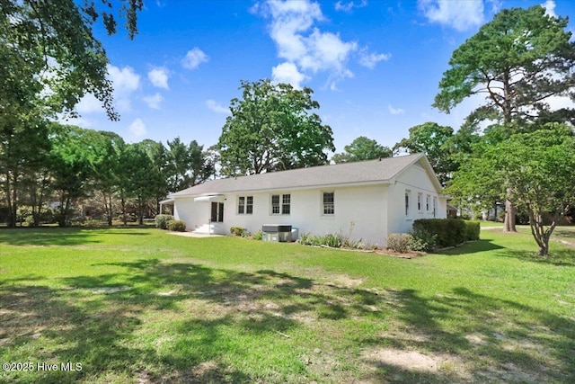 1102 Elanor Ave, Goldsboro, NC 27530 - back of house with a lawn and stucco siding