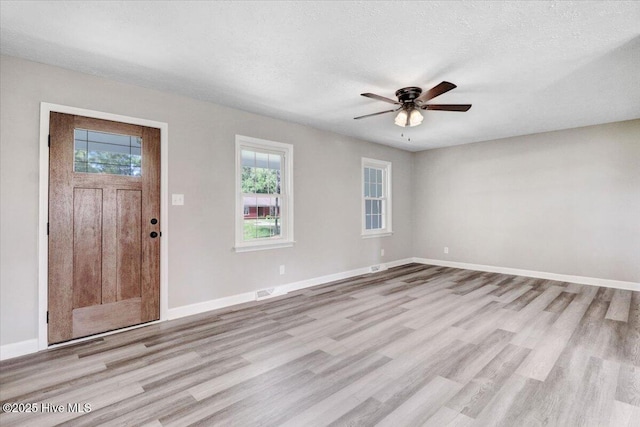1102 Elanor Ave, Goldsboro, NC 27530 - entrance foyer featuring light wood-type flooring, a ceiling fan, baseboards, and a textured ceiling