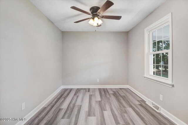 1102 Elanor Ave, Goldsboro, NC 27530 - unfurnished room with wood finished floors, a ceiling fan, and baseboards
