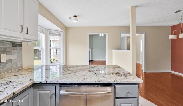 416 Point View Ct, Wilmington, NC 28411 - kitchen featuring stainless steel dishwasher, decorative backsplash, wood finished floors, light stone counters, and a textured ceiling