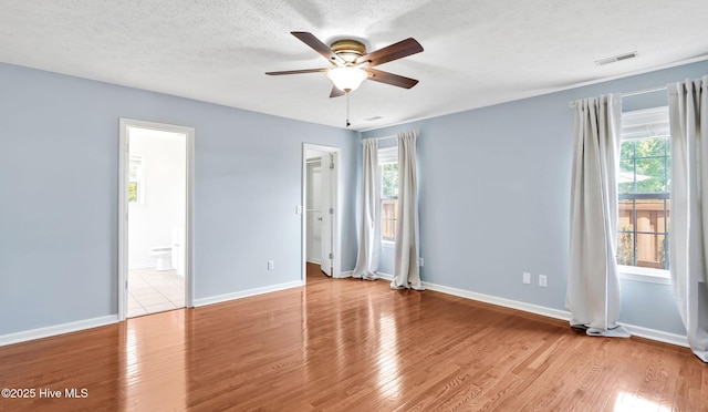 416 Point View Ct, Wilmington, NC 28411 - unfurnished bedroom with multiple windows, a textured ceiling, wood finished floors, and baseboards