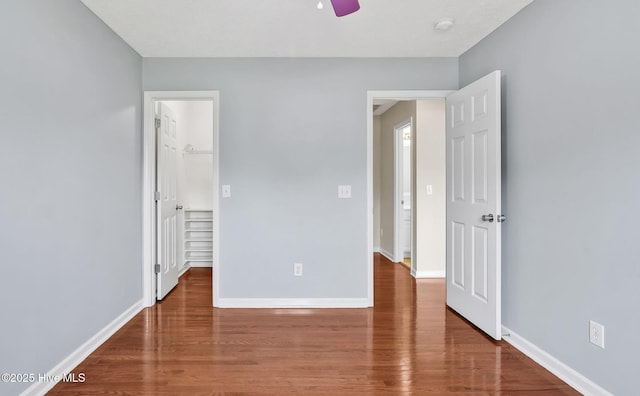 416 Point View Ct, Wilmington, NC 28411 - unfurnished bedroom with wood finished floors, baseboards, and a walk in closet