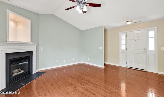 416 Point View Ct, Wilmington, NC 28411 - unfurnished living room featuring a ceiling fan, wood finished floors, a glass covered fireplace, baseboards, and vaulted ceiling