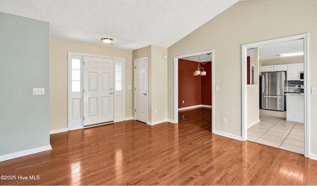 416 Point View Ct, Wilmington, NC 28411 - entrance foyer with light wood-type flooring, baseboards, and vaulted ceiling