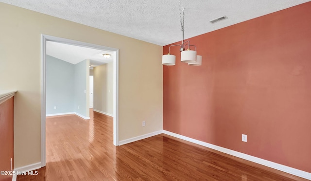 416 Point View Ct, Wilmington, NC 28411 - spare room with wood finished floors, a textured ceiling, and baseboards