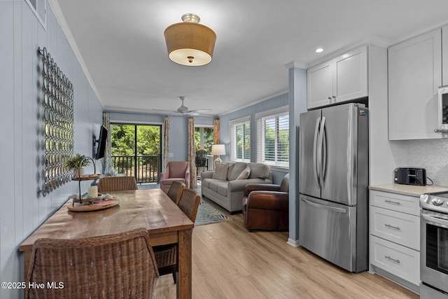2008 E Fort Macon Rd Unit A-1, Atlantic Beach, NC 28512 - dining space featuring ornamental molding, healthy amount of natural light, light wood finished floors, and a ceiling fan