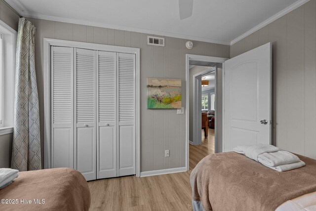 2008 E Fort Macon Rd Unit A-1, Atlantic Beach, NC 28512 - bedroom with light wood finished floors, ornamental molding, a closet, baseboards, and ceiling fan