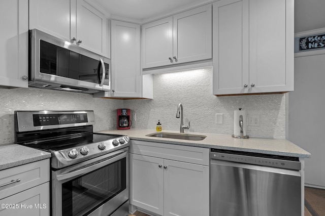 2008 E Fort Macon Rd Unit A-1, Atlantic Beach, NC 28512 - kitchen featuring appliances with stainless steel finishes, a sink, decorative backsplash, and white cabinets