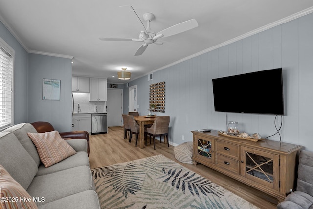 2008 E Fort Macon Rd Unit A-1, Atlantic Beach, NC 28512 - living area with light wood finished floors, ornamental molding, and ceiling fan
