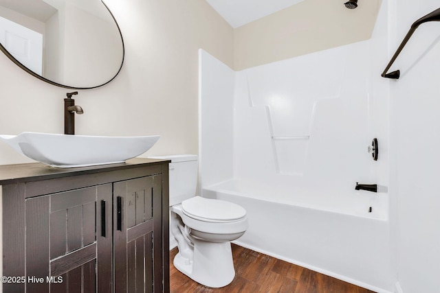 562 Anchor Way, Kure Beach, NC 28449 - bathroom featuring wood finished floors, toilet, vanity, and washtub / shower combination