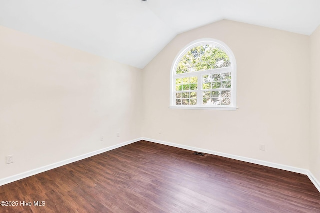 562 Anchor Way, Kure Beach, NC 28449 - spare room with dark wood-style floors, lofted ceiling, and baseboards