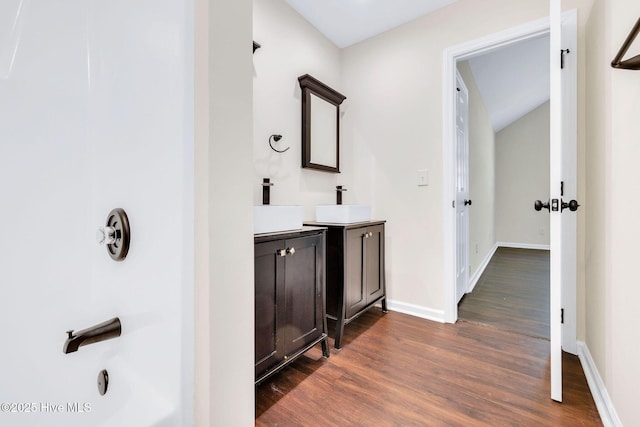562 Anchor Way, Kure Beach, NC 28449 - bathroom with wood finished floors, vanity, baseboards, and lofted ceiling