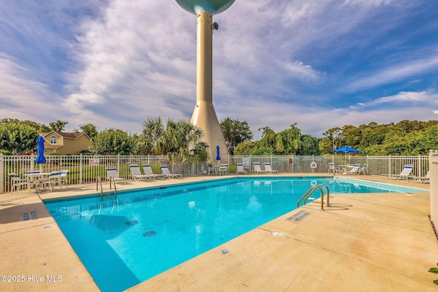 562 Anchor Way, Kure Beach, NC 28449 - community pool with a patio and view of wooded area