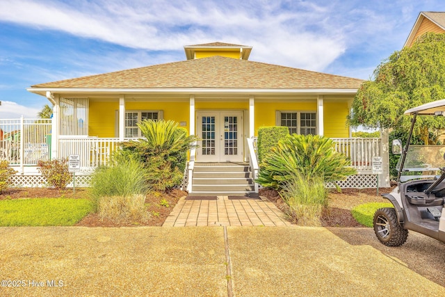 562 Anchor Way, Kure Beach, NC 28449 - bungalow-style home featuring french doors, a porch, and roof with shingles