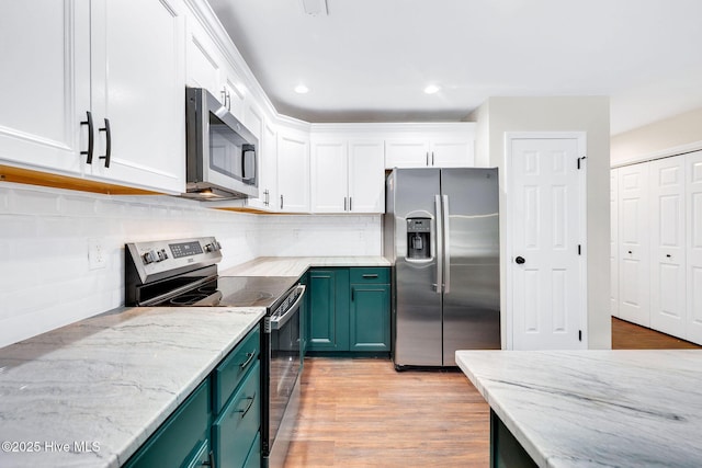 562 Anchor Way, Kure Beach, NC 28449 - kitchen featuring stainless steel appliances, white cabinetry, light stone countertops, backsplash, and recessed lighting