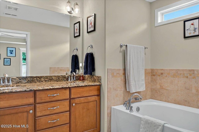 2121 Maple Leaf Dr, Southport, NC 28461 - bathroom featuring double vanity and a garden tub