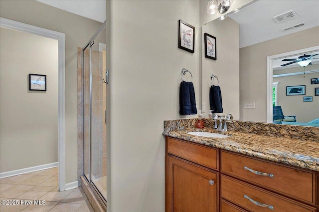 2121 Maple Leaf Dr, Southport, NC 28461 - full bath featuring vanity, a stall shower, tile patterned floors, baseboards, and a ceiling fan