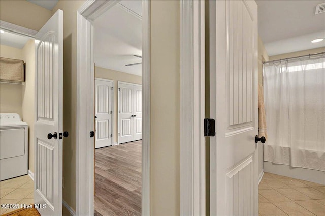 2121 Maple Leaf Dr, Southport, NC 28461 - hallway with washer / clothes dryer and light tile patterned floors