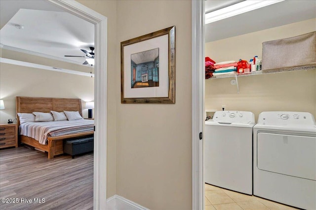 2121 Maple Leaf Dr, Southport, NC 28461 - laundry area with washing machine and dryer, a ceiling fan, baseboards, and light wood-type flooring