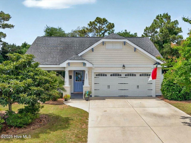 2121 Maple Leaf Dr, Southport, NC 28461 - view of front of house with a shingled roof, an attached garage, and concrete driveway