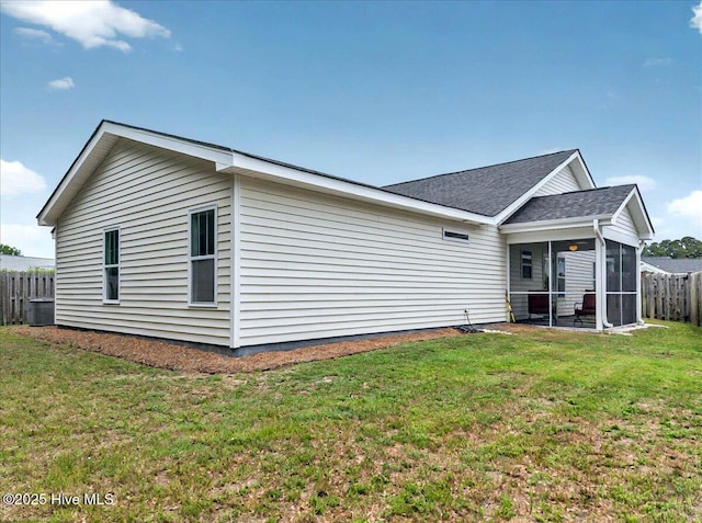 2121 Maple Leaf Dr, Southport, NC 28461 - back of house with a sunroom, roof with shingles, and central air condition unit