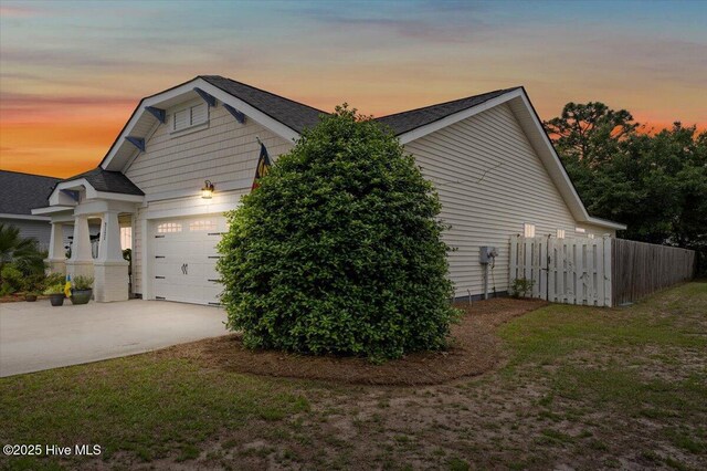 2121 Maple Leaf Dr, Southport, NC 28461 - view of home's exterior with an attached garage, driveway, and roof with shingles