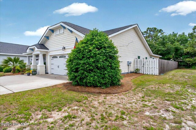 2121 Maple Leaf Dr, Southport, NC 28461 - view of home's exterior featuring a garage and driveway