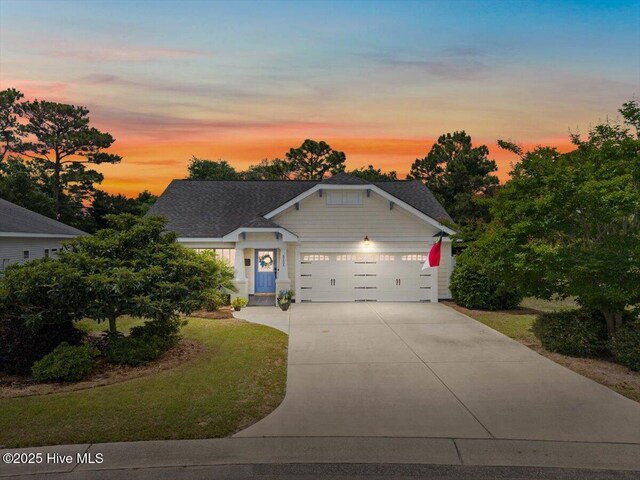 2121 Maple Leaf Dr, Southport, NC 28461 - view of front of home featuring a garage, driveway, and a front lawn