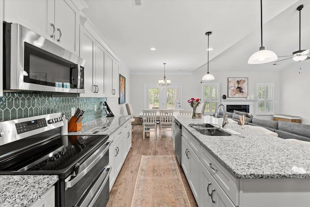 1225 Morganton Rd, Pinehurst, NC 28374 - kitchen with appliances with stainless steel finishes, light wood-style flooring, a sink, a center island with sink, and open floor plan
