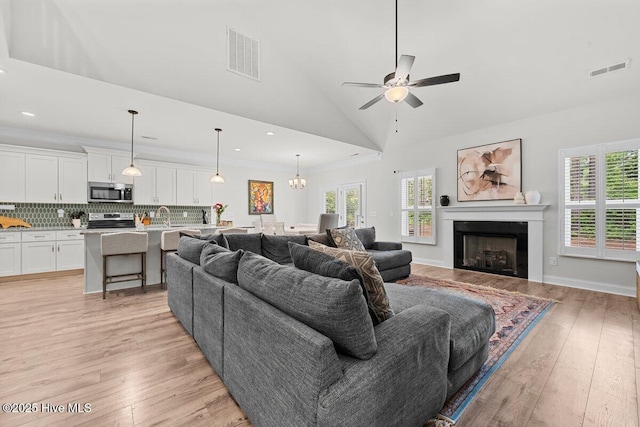 1225 Morganton Rd, Pinehurst, NC 28374 - living room featuring ceiling fan, light wood finished floors, a fireplace, a chandelier, and recessed lighting