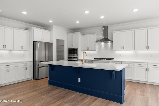3924 Watersail Dr Unit 88, Wilmington, NC 28409 - kitchen featuring appliances with stainless steel finishes, wall chimney range hood, a sink, a breakfast bar, and crown molding