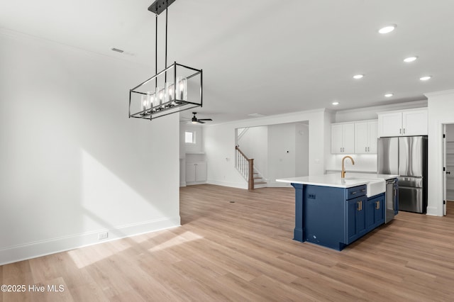 3924 Watersail Dr Unit 88, Wilmington, NC 28409 - kitchen with blue cabinets, ornamental molding, stainless steel appliances, recessed lighting, and white cabinetry