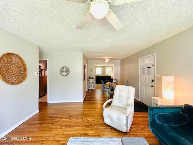 502 Dogwood Ln, Jacksonville, NC 28540 - living area featuring a ceiling fan, wood finished floors, baseboards, and a textured ceiling