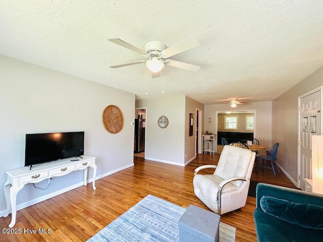 502 Dogwood Ln, Jacksonville, NC 28540 - living room with a ceiling fan, a textured ceiling, wood finished floors, and baseboards