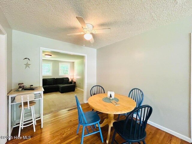502 Dogwood Ln, Jacksonville, NC 28540 - dining room featuring a ceiling fan, wood finished floors, a textured ceiling, and baseboards