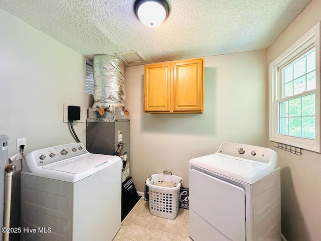 502 Dogwood Ln, Jacksonville, NC 28540 - laundry area with cabinet space, independent washer and dryer, a textured ceiling, and light tile patterned floors
