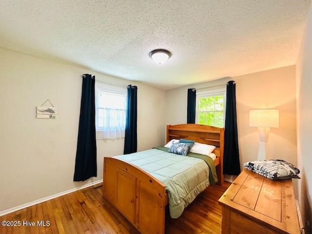 502 Dogwood Ln, Jacksonville, NC 28540 - bedroom with hardwood / wood-style flooring, baseboards, and a textured ceiling