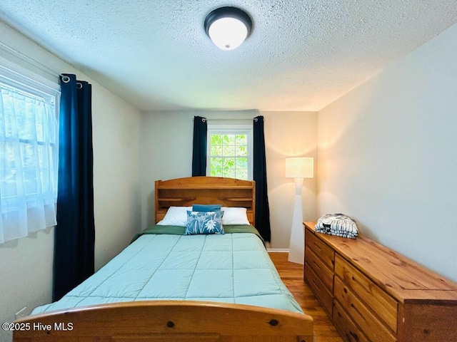 502 Dogwood Ln, Jacksonville, NC 28540 - bedroom with wood finished floors and a textured ceiling