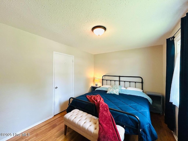 502 Dogwood Ln, Jacksonville, NC 28540 - bedroom featuring wood finished floors, baseboards, and a textured ceiling