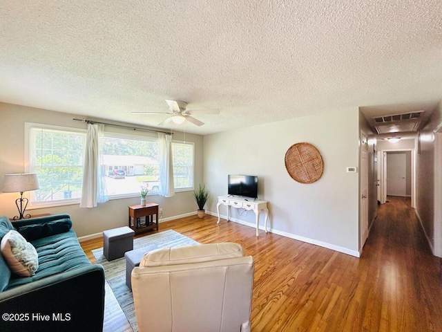 502 Dogwood Ln, Jacksonville, NC 28540 - living area featuring wood finished floors, ceiling fan, a textured ceiling, and baseboards
